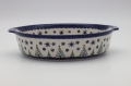 Round ceramic serving dish with handles – Bolesławiec pottery, hand-decorated with traditional patterns. Perfect for serving meats, salads, and appetizers. Stylish and durable Polish ceramic.