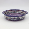 Round ceramic serving platter with handles – hand-decorated Bolesławiec pottery with traditional patterns. Perfect for serving meats, salads, snacks, and family dishes. Durable and elegant Polish ceramic.